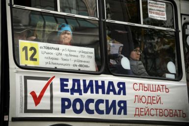 Opposition leaders hope to deal a blow to President Vladimir Putin's United Russia party, whose adverts can be seen on buses in Siberian city Tomsk