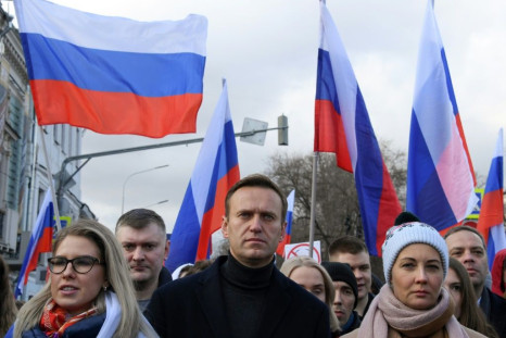 Alexei Navalny (C) had been campaigning for tactical voting before he was poisoned