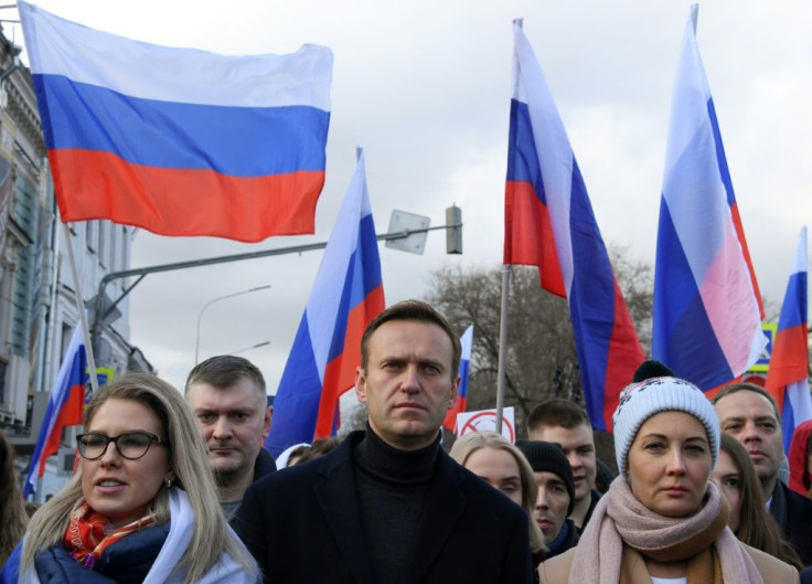 Alexei Navalny (C) had been campaigning for tactical voting before he was poisoned