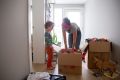 Levi Benjamin-Brown, 5, helps his mother Kyla Brown unpack boxes of toys at their new home in El Cerrito, California, where the family moved from San Francisco