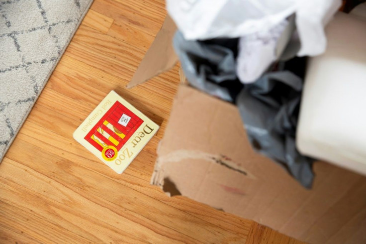 A small child's book lies on the floor next to unpacked boxes in Kyla Brown's new home in El Cerrito, California on September 11, 2020