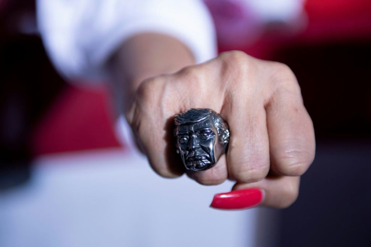 A supporter shows a ring featuring the face of US President Donald Trump during a campaign rally at the Minden-Tahoe airport in Minden, Nevada on September 12, 2020