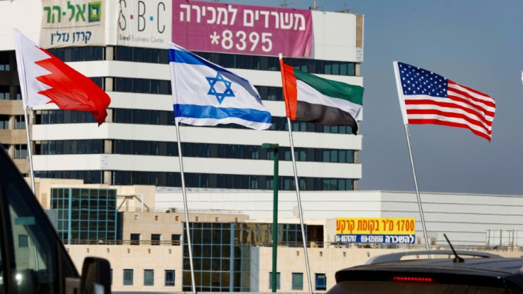 The national flags of (L-R) Bahrain, Israel, the United Arab Emirates, and the United States are flown along a road in Israeli resort city of Netanya after the two Gulf countries agreed to normalise ties with the Jewish state