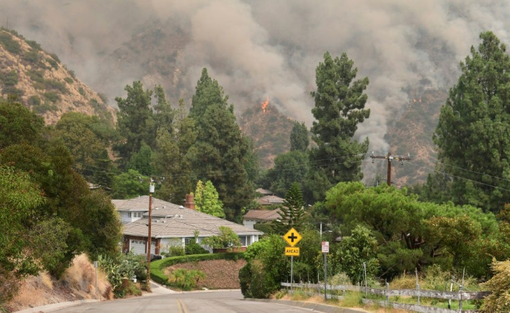 The Bobcat Fire burns on a hillsides behind homes in Arcadia, California on September 13, 2020