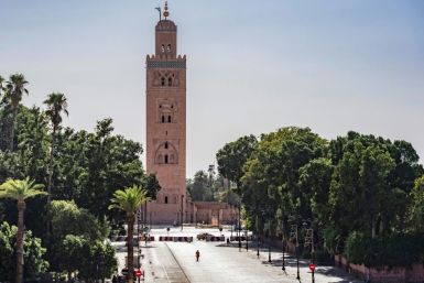 A few people walk by next to the Kutubiyya mosque's minaret tower at the Jemaa el-Fna square in the Moroccan city of Marrakesh on September 8, 2020, currently empty of its usual crowds due to the COVID-19 pandemic