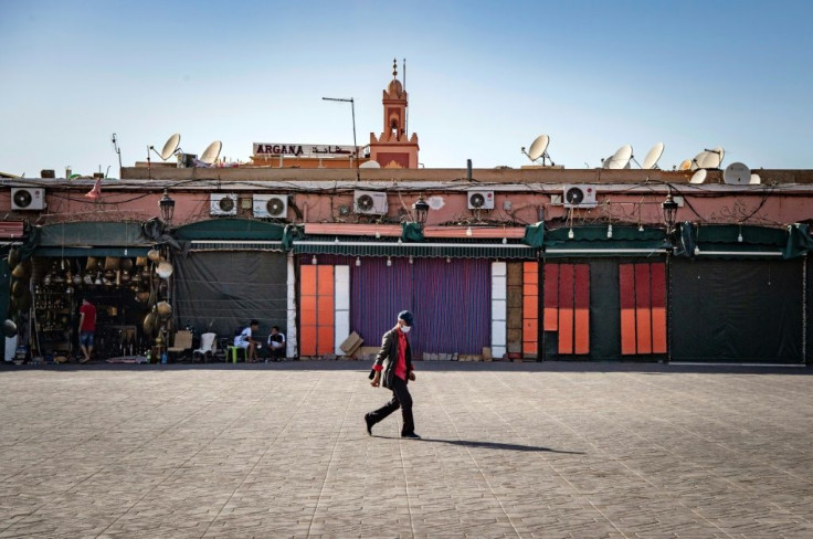 A man walks by mostly-closed stalls at the Jemaa el-Fna square in the Moroccan city of Marrakesh on September 8, 2020