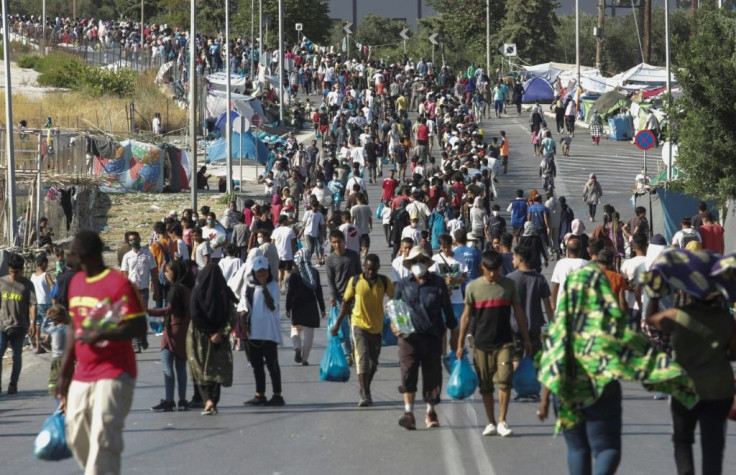 Hundreds of migrants have reluctantly made their way to the new site in the searing heat