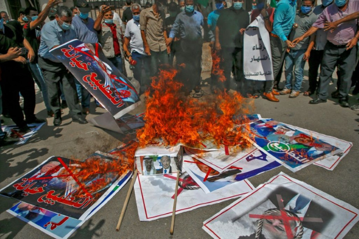 Demonstrators in Gaza City burn pictures depicting leaders of Israel, Bahrain, the United Arab Emirates and the United States to denounce the accords between Israel and Bahrain and the UAE