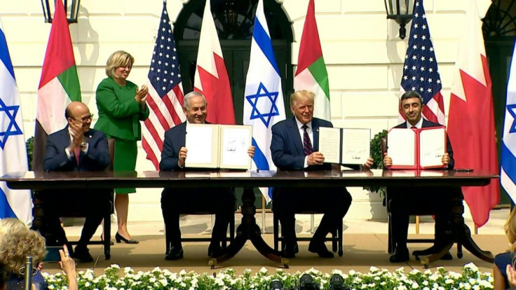 IMAGES Israel's Prime Minister Benjamin Netanyahu signs the Abraham Accords along with the Foreign Ministers of the UAE and Bahrain in a deal to normalize relations brokered by US President Donald Trump.