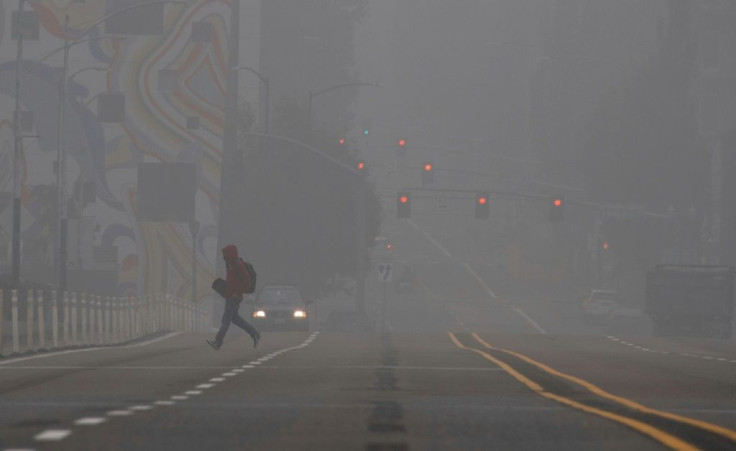 A man crosses a street in downtown Portland, Oregon where air quality due to smoke from wildfires was measured to be amongst the worst in the world, September 14, 2020