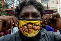 This fan in Chennai has a facemask decorated with pictures of Chennai Super Kings players