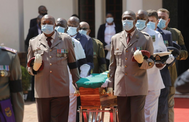 Farewell: Pallbearers bring the coffin into the Hellenic Cultural Centre in Johannesburg