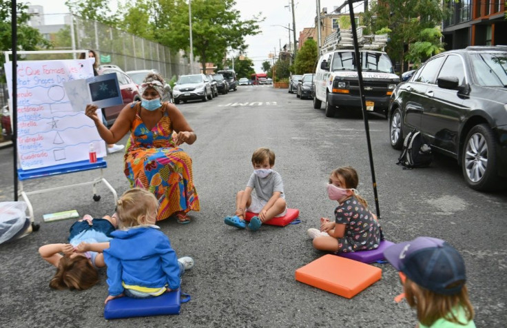 A teacher conducts a lesson with students during an outdoor learning demonstration for New York City schools in front of the Patrick F. Daly public school on September 02, 2020 in the Brooklyn borough of New York City