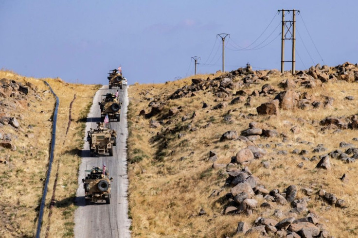 A convoy of US armored vehicles patrols the northeast Syrian town of Qahtaniyah at the border with Turkey, in October 2019