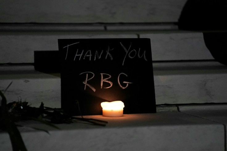 A sign and a candle form a makeshift memorial on the steps of the Supreme Court building, in honor of Ruth Bader Ginsburg