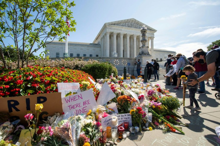 People place flowers outside of the US Supreme Court in Washington in memory of Justice Ruth Bader Ginsburg