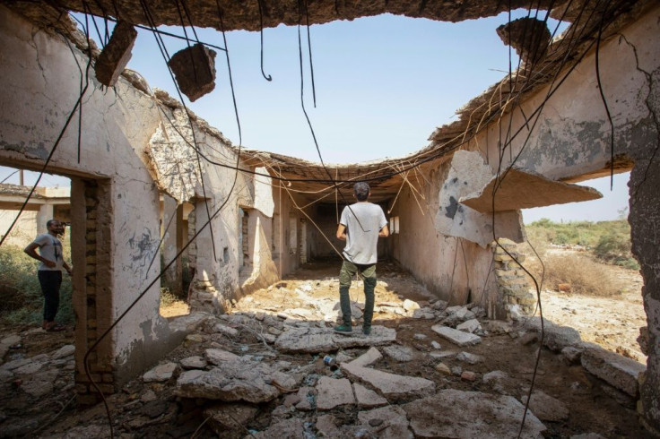 Memories of the war run deep and the ruins of buildings remain -- such as this in Iraq's al-Faw region -- but leaders in the two countries now have close ties