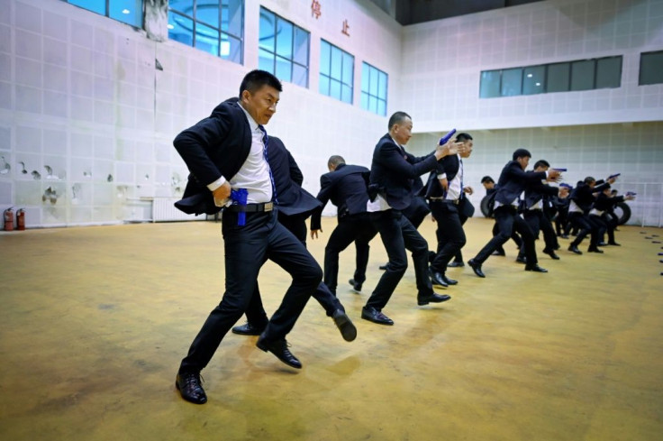 Students in matching black business suits toil from dawn until midnight at the bodyguard school in the eastern Chinese city of Tianjin