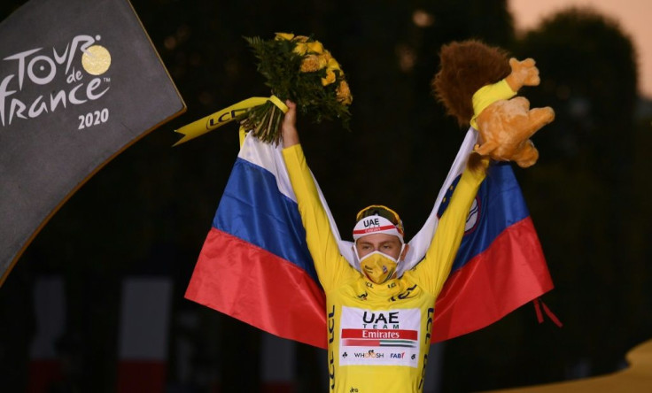 Slovenia's Tadej Pogacar wearing the overall leader's yellow jersey and draped in his national flag