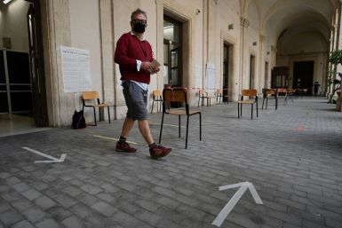 Polling stations opened Sunday for the two-day vote, despite a threatened resurgence of the coronavirus in Italy