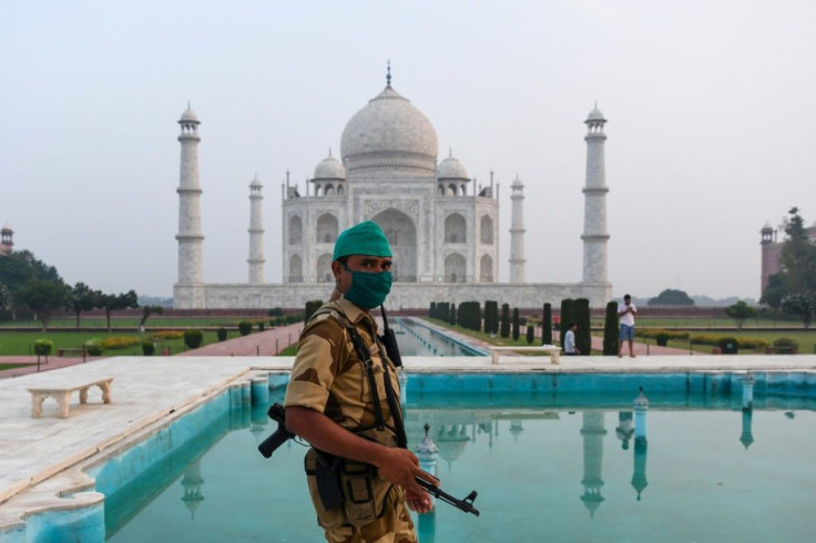 A security guard patrols at the Taj Mahal, which reopened on Monday for the first time since March