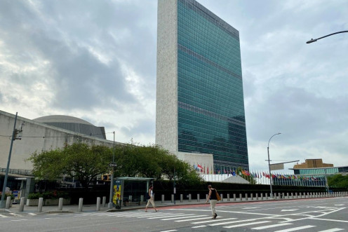 People walk on an empty First Avenue near the United Nations headquarters in New York on September 9, 2020.