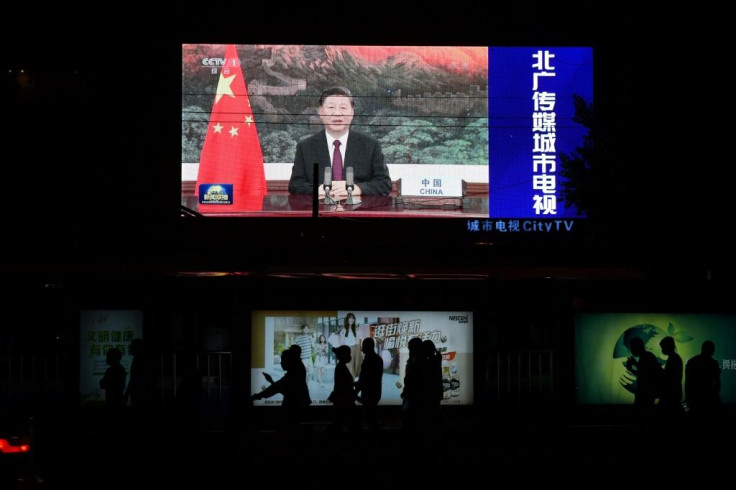 An image of Chinese President Xi Jinping appearing by video link at the United Nations General Assembly is seen on an outdoor screen in Beijing
