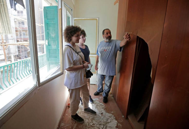 Dikran Geuzubeuyukian and his children inspect their damaged home -- which the Armenian General Benevolent Union is helping to repair