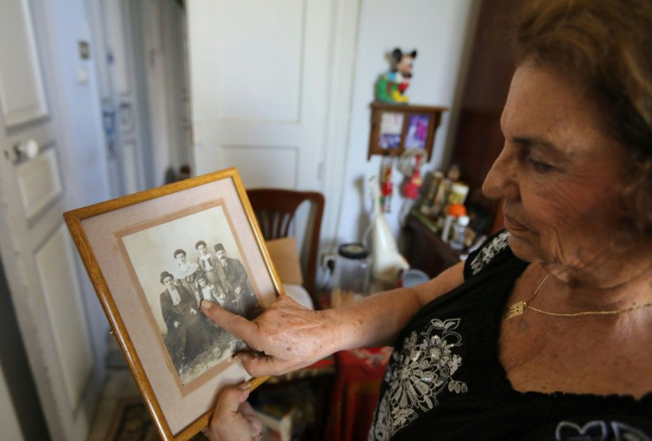 Relatives of Vany Bandikian -- here showing a photos of her family -- urged her to emigrate to the US, but she wants to stay in her home in Beirut