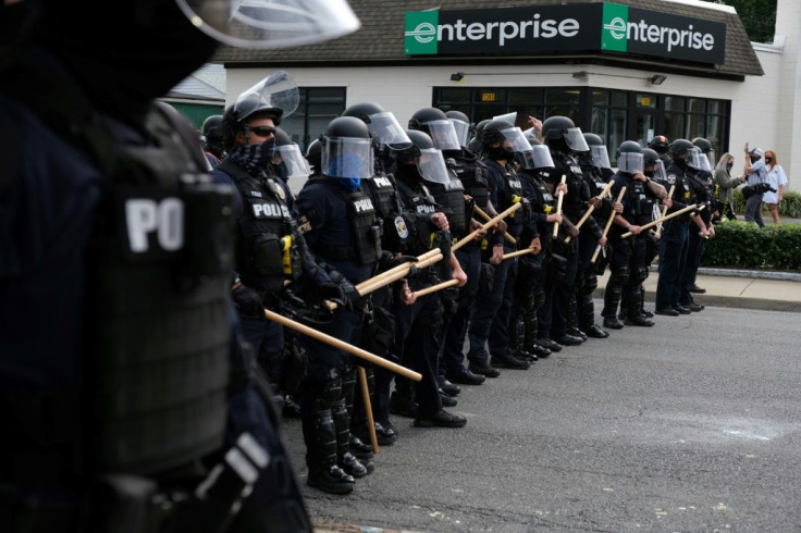 Police confront protesters in Louisville after charges were announced in the Breonna Taylor case