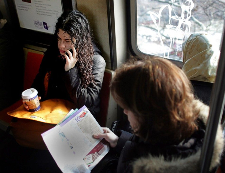 Woman talks on her cell phone on a subway train