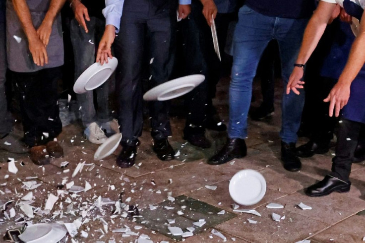 Restaurant workers in Tel Aviv break plates in protest against the new Israeli lockdown