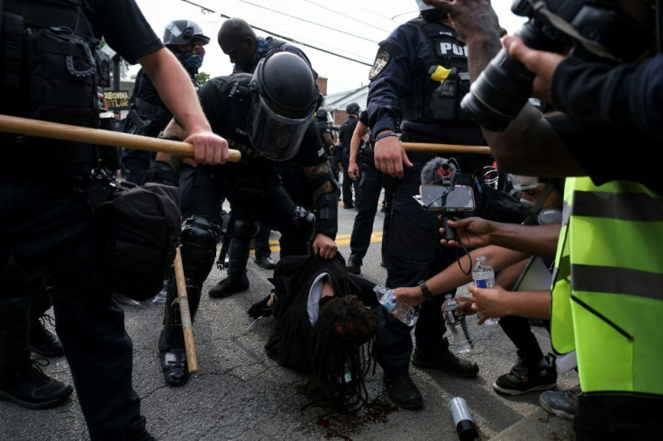 A protester is detained while bleeding from the head in Louisville, Kentucky, on September 23, 2020, after the announcement that no one will be charged with killing Breonna Taylor, who has become a symbol of the Black Lives Matter movement