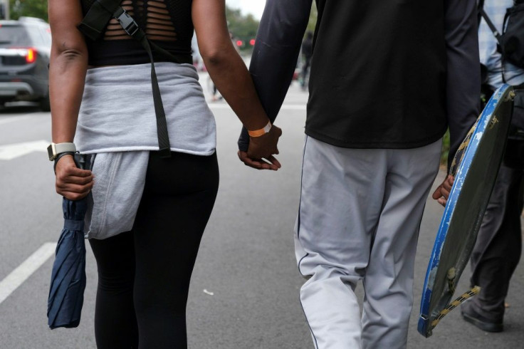 Protesters hold hands while marching during the rally demanding justice for Breonna Taylor in Louisville, Kentucky, on September 23, 2020