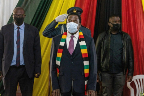 Zimbabwe's President Emmerson Mnangagwa (center), seen here at a meeting with civil society organizations in August 2020, has appealed to the United Nations to condemn Western sanctions