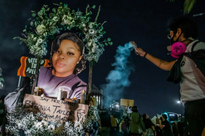 Protesters hold up a picture of Breonna Taylor as they march against police brutality in Los Angeles, on September 23, 2020