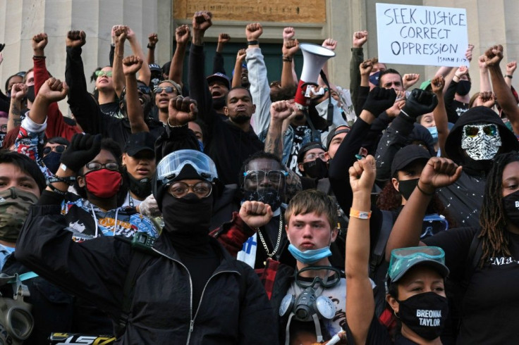 Protesters are seen on the steps of the Louisville Metro Hall on September 24, 2020