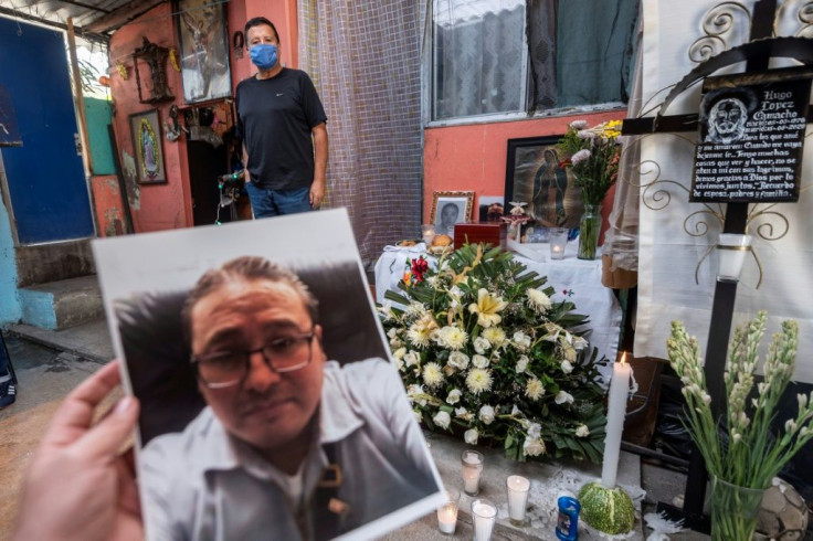 A relative shows a photo of Mexican hospital worker Hugo Lopez Camacho, who died of Covid-19