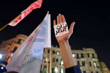 An Egyptian protester holds up his hand with a slogan reading in Arabic: "Egyptian girls are a red line" during a 2013 demonstration in Cairo against sexual harassment