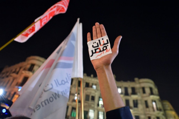 An Egyptian protester holds up his hand with a slogan reading in Arabic: "Egyptian girls are a red line" during a 2013 demonstration in Cairo against sexual harassment