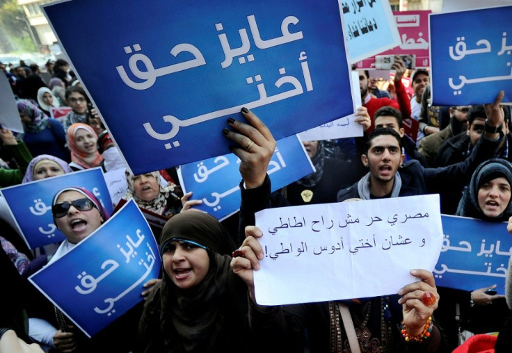 Egyptian women hold placards that read in Arabic "I want my sister's right" as they protest against military council violations and virginity tests on women