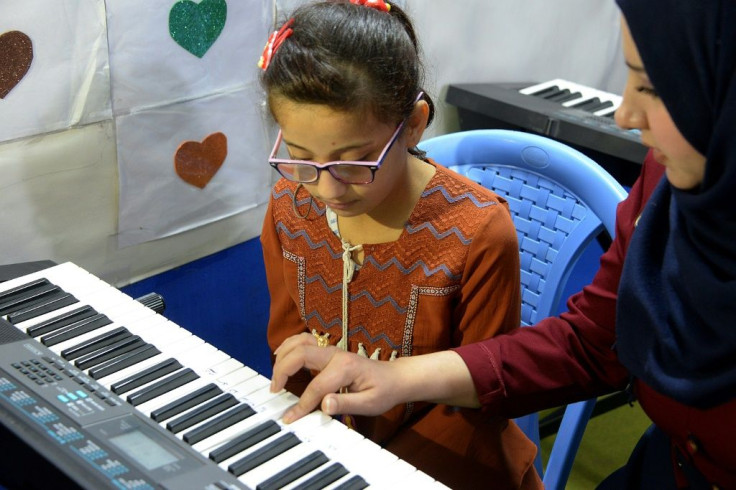 A girl with special needs practises a short eight-note tune to improve her motor skills at a private rehabilitation centre in Mosul