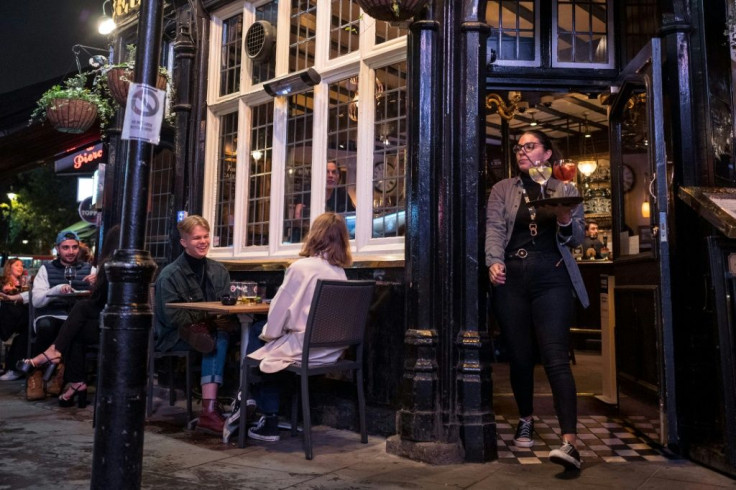 British pubs and bars were to start closing early after the government imposed new virus curbs