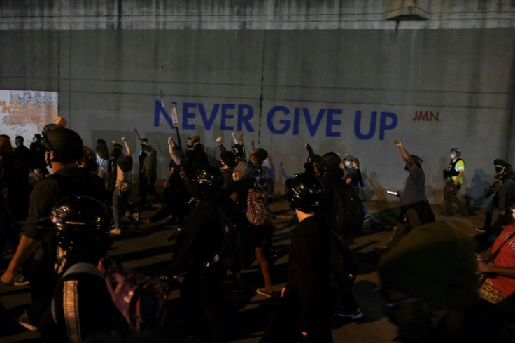 Protestors march as they protest the lack of criminal charges in the police killing of Breonna Taylor, in downtown Louisville, Kentucky on September 24, 2020