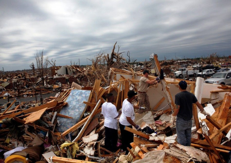 Residents look for belongings from a destroyed apartment building in Joplin, Missouri
