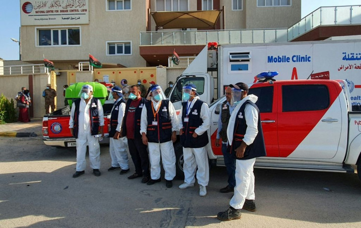 Libyan medical workers prepare for an awareness campaign on Covid-19 at Friday market shops in the capital Tripoli