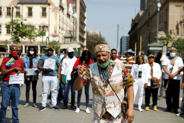 A member of the Khoisan community speaks before joining a protest march under the banner of "#Put South Africans First" in Pretoria