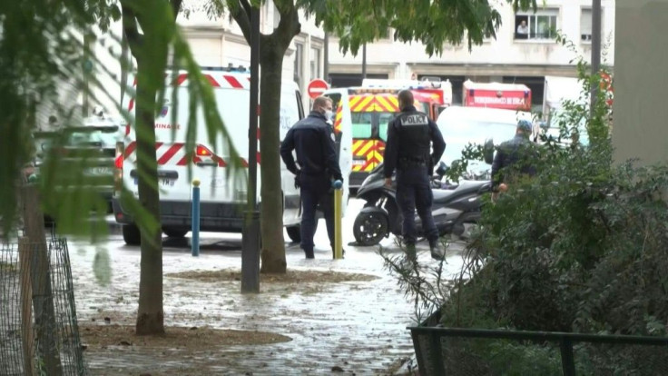 Photos show a victim badly injured on the ground, a bloody knife on the ground and a bloodstain. Images show firefighters arriving in a building with a stretcher after two people were stabbed in the street near the former premises of Charlie Hebdo.