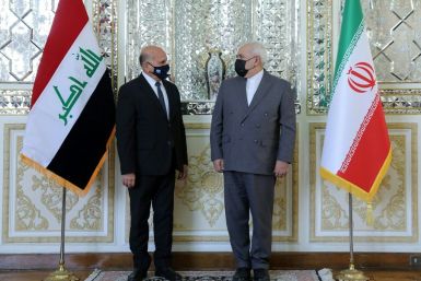 A handout picture provided by the Iranian Foreign Ministry on September 26, 2020 shows Foreign Minister Mohammad Javad Zarif (R) welcoming his Iraqi counterpart Fuad Hussein at the foreign ministry in Tehran