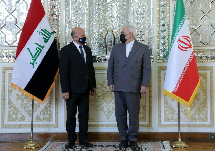 A handout picture provided by the Iranian Foreign Ministry on September 26, 2020 shows Foreign Minister Mohammad Javad Zarif (R) welcoming his Iraqi counterpart Fuad Hussein at the foreign ministry in Tehran